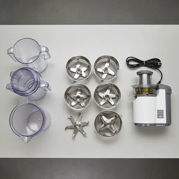 Various disassembled parts of a plastic juicer laid out for recycling preparation.