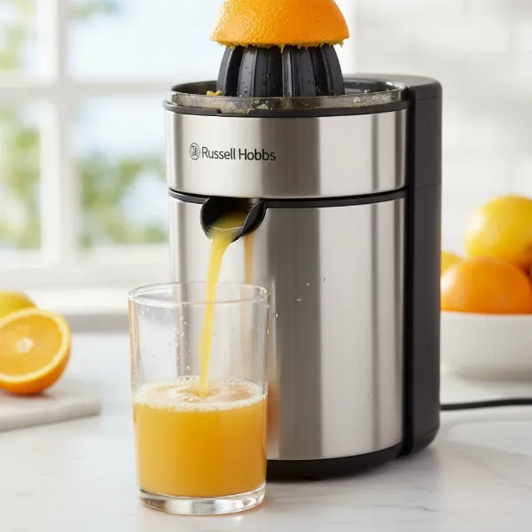 Fresh orange juice being extracted into a glass by the Russell Hobbs Classics Citrus Press